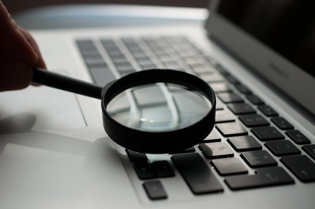 Magnifying glass on a laptop keyboard