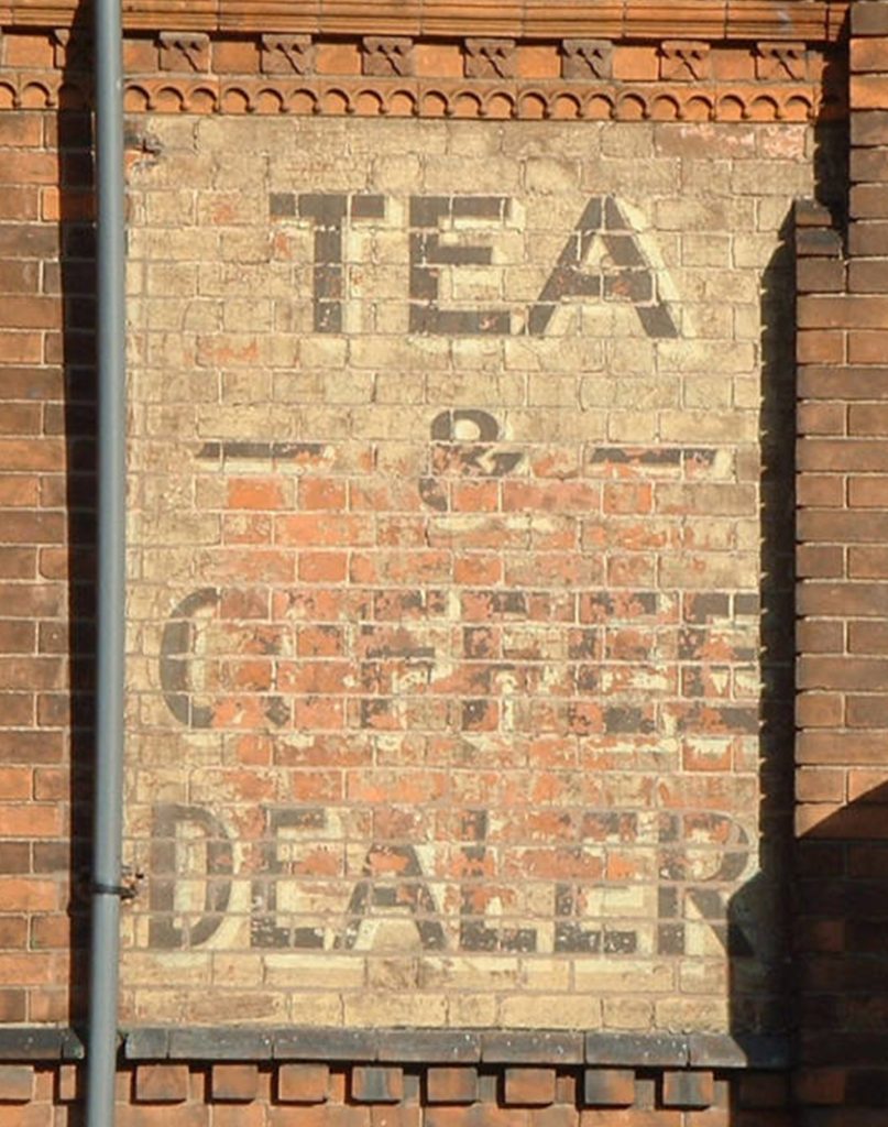 Colour photograph of a ghost sign for a tea and coffee dealer on Saffron Lane.
