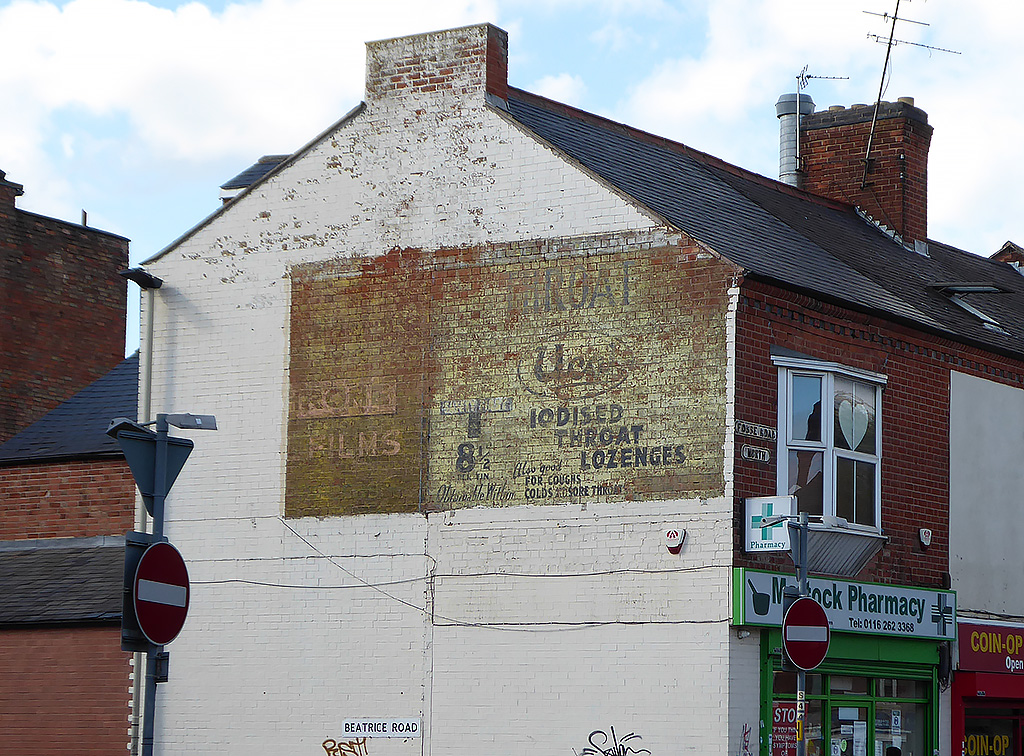 Photo of painted advertisement for UCAL iodised throat lozenges.