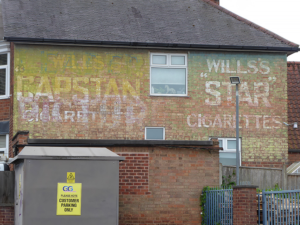 Photo of painted advertisement for a variety of products.