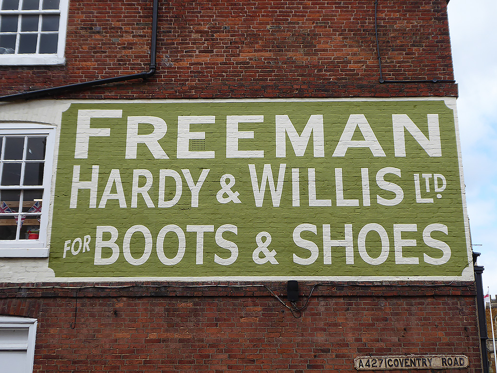 Photo of painted advertisement for Freeman, Hardy & Willis, boots and shoes.