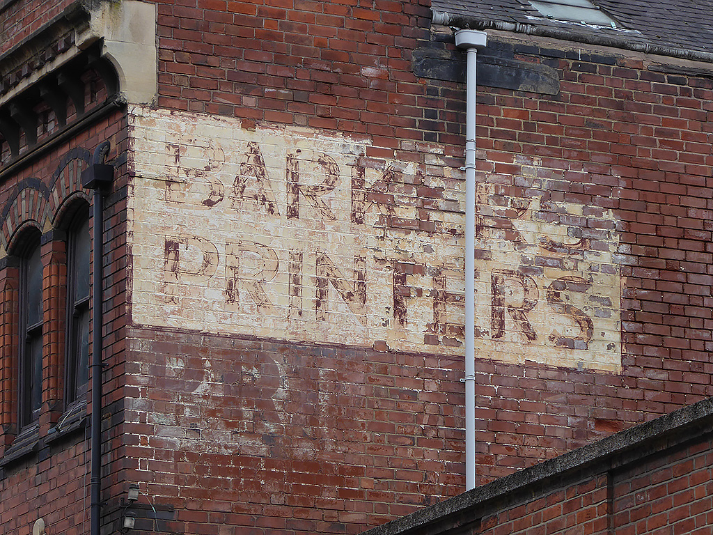 Photo of painted advertisement for Barkers, printers.