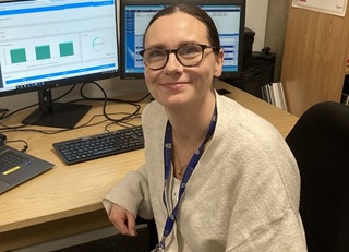 Assistant Digital Archivist, Ruth Maguire, at a computer desk