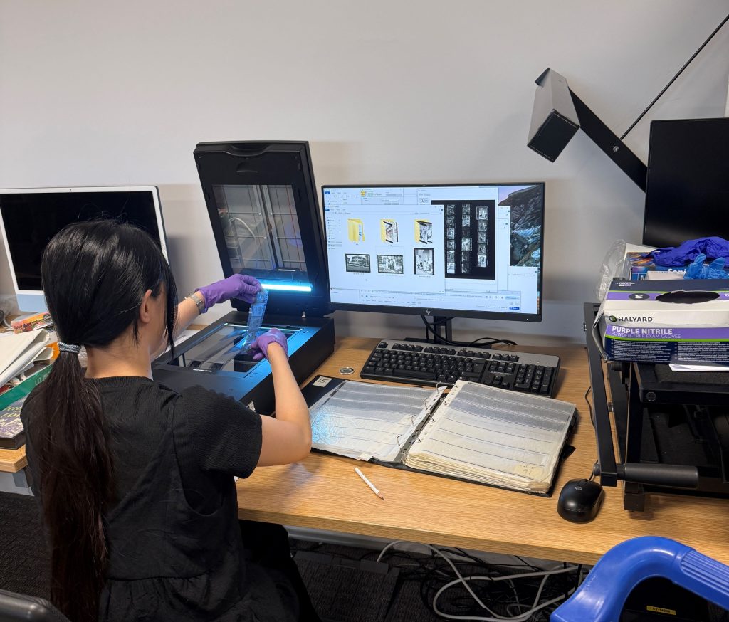 A student digitises film negatives on a scanner