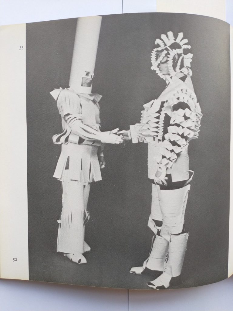 Image of two people in elaborate paper costumes