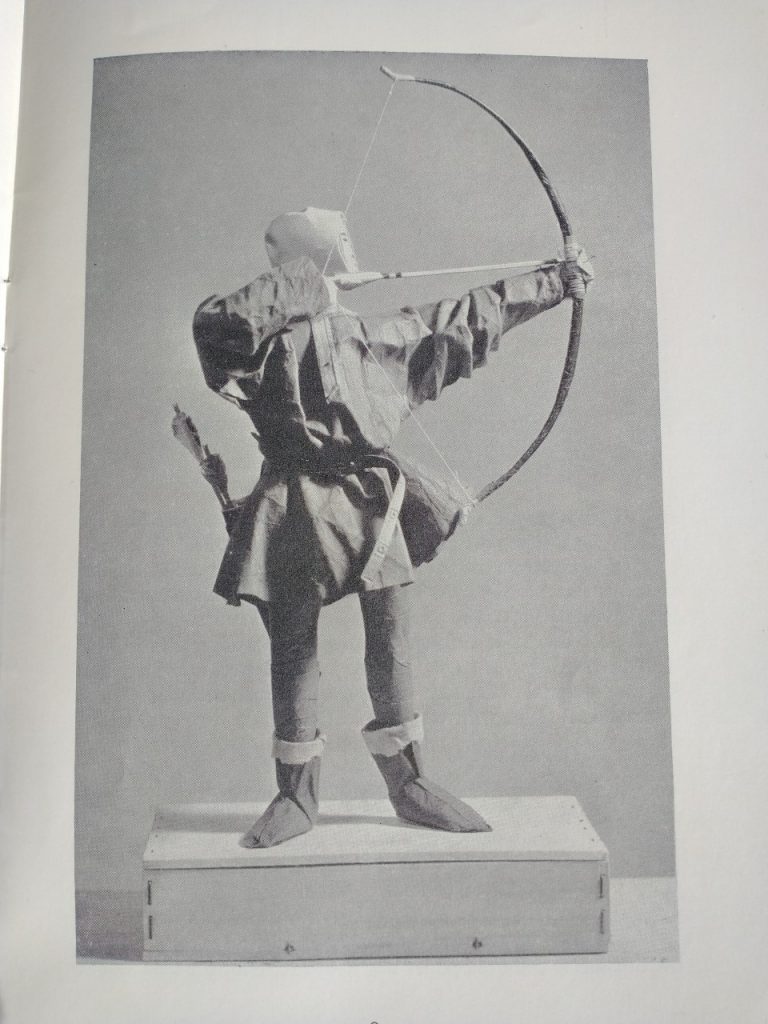 Image of the finished figure with a paper of cloth costume. the figure is of a Robin Hood type character.