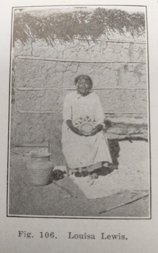 Photo from the Pima book of Louisa Lewis holding one of her baskets.