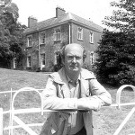 Auberon Waugh stands in front of Combe Florey House